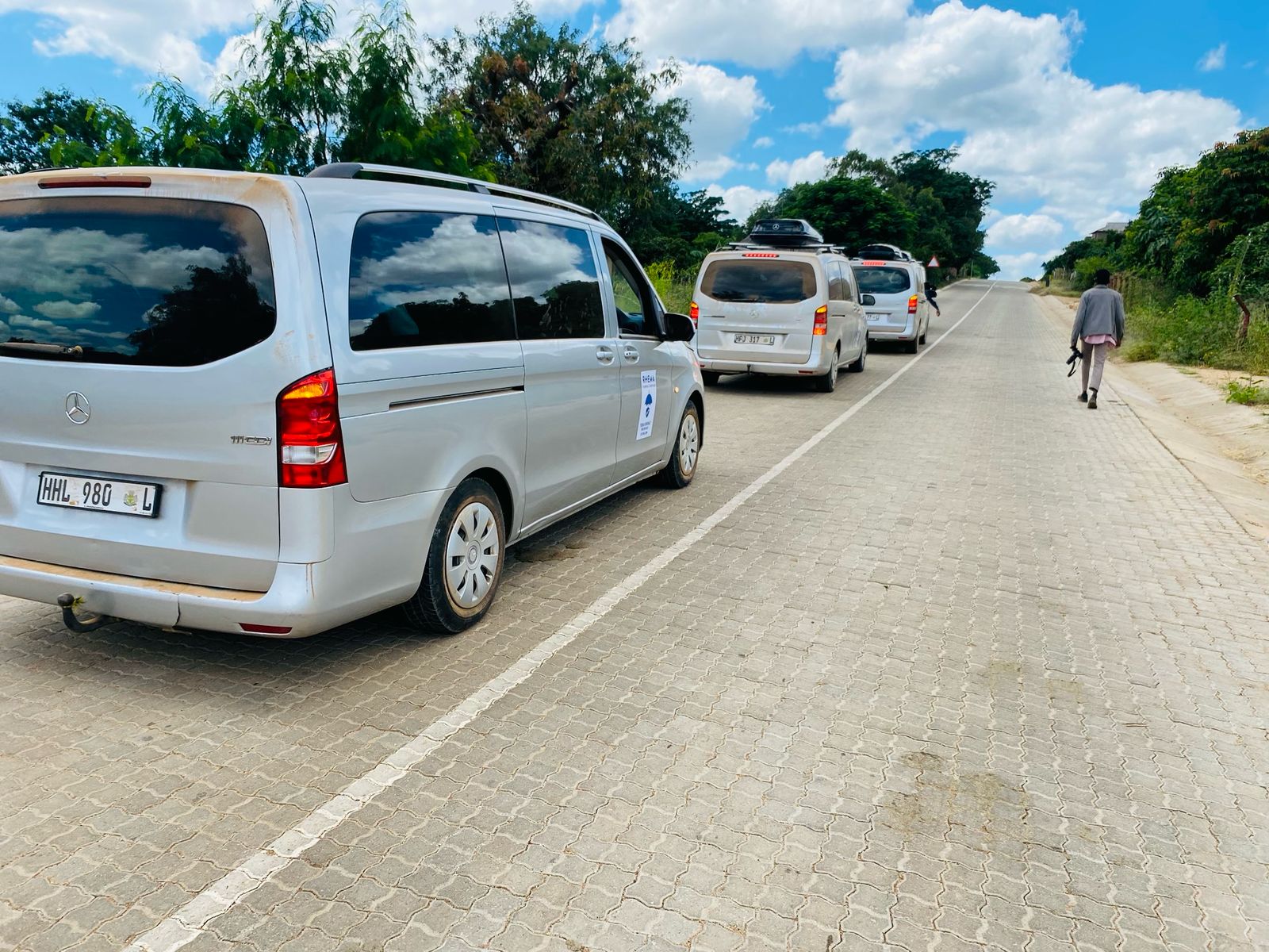 Funeral convoy parked along the roadside